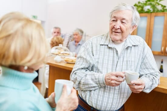 Senior in relaxed conversation with elderly woman